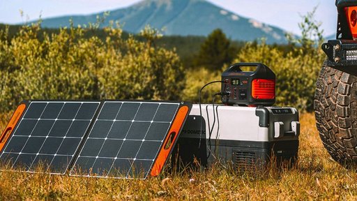 Jackery Solargenerator 500 wird mit Solarpanel auf einem Feld aufgeladen.